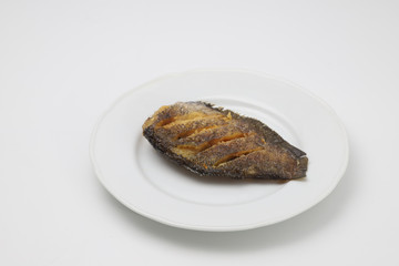 Crispy Gourami fish on white plate on white background