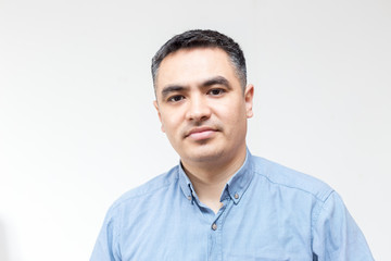 Fototapeta premium Attractive handsome smiling positive happy business man. Closeup portrait of a polite middle age man wearing a blue shirt