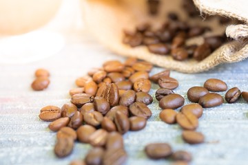 The roasted coffee beans on stone table background. Selective focus