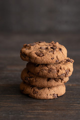 Chocolate cookies with chocolate chip on wooden background.