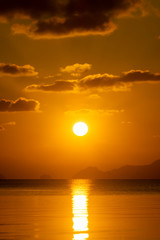 Sunset sky at the lake with dark clouds.