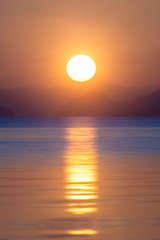 Sunset sky at the lake with dark clouds.
