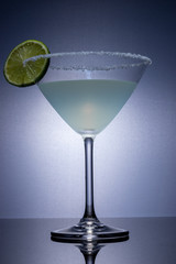 Cocktail glass on a reflective surface