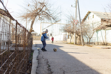 children play ball on the street