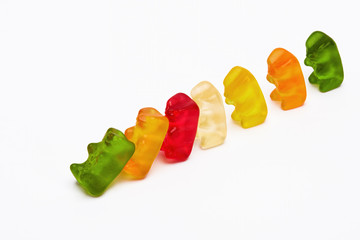 Domino effect concept with colorful gummy bears