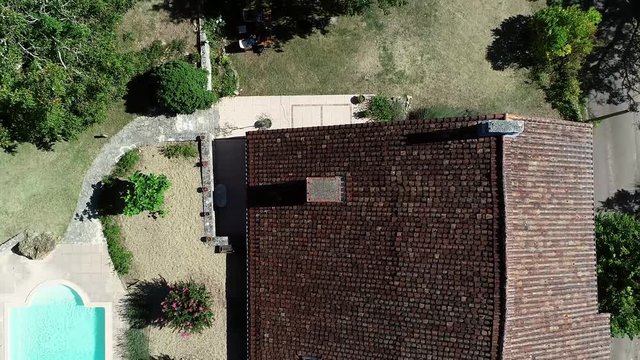 Aerial top down view of villa located in France taking off from chimney showing swimming pool typical French country house also often used as rental place for summer vacation 4k high resolution