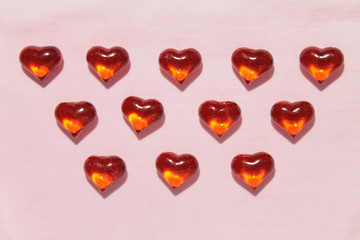 Glass red hearts on a pink background. Stock photo for valentine's day