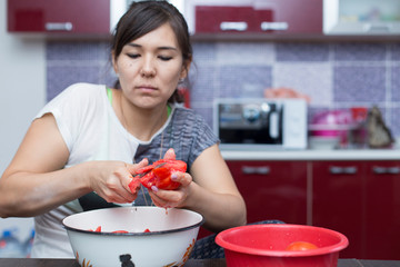 Girl preparing tomato salad