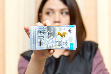 Money Kazakhstan Tenge. in the hands of a girl
