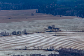 Close up view to snow covered field with trees and road. Novohradske mountain, Czech republic