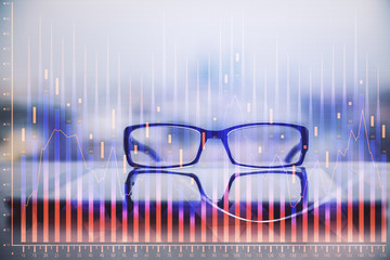 Financial graph hologram with glasses on the table background. Concept of business. Double exposure.