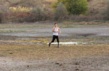 a young man walks in dirty, salty ecological places