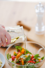 add vegetable oil to the salad. vegan food. Pour oil into the salad