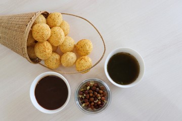 Panipuri or Golgappa. Indian street snack made of fried mint flavors puries, mint chutney, sprouts and dates, tamarind chutney. Indian Chat.