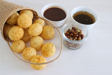 Panipuri or Golgappa. Indian street snack made of fried mint flavors puries, mint chutney, sprouts and dates, tamarind chutney. Indian Chat.