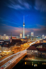 The skyline of Berlin, Germany, during dusk time with a starry sky and blurred traffic motion on...