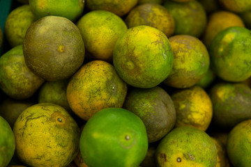 Green fresh whole ripe green tangerine as a texture. Food concept. Tropical and exotic fruits. Healthy and vitamin food concept.
