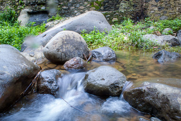 Naklejka na ściany i meble spring water mountain river shot with long exposure, Beautiful flowing water 