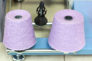 lilac thread on a modern machine for twisting threads in production