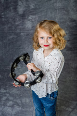 girl playing tambourine