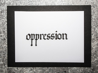 Handwritten word Oppression. Gothic script calligraphy.