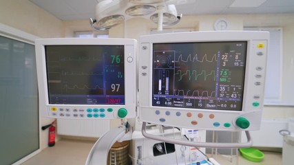 Special monitors showing heart rate and pulse. Electrocardiogram on a display. Graphics of electrical activity of patient's heart beat on two modern monitors.