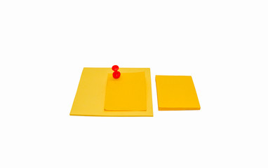 Yellow sticky notes and red pin needle isolated on white background