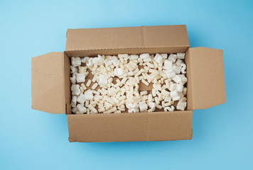 open rectangular brown cardboard box with white foam filling