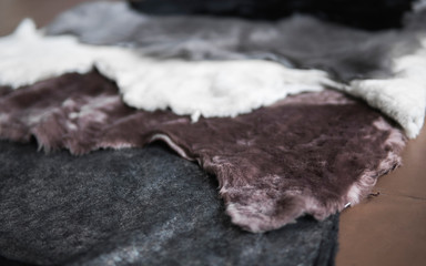 Solid fur pieces of different colors for use in sewing warm and comfortable shoes at a shoe factory.