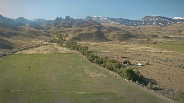Aerial flying over a ranch and mountains in the countryside. Cody, Wyoming, USA