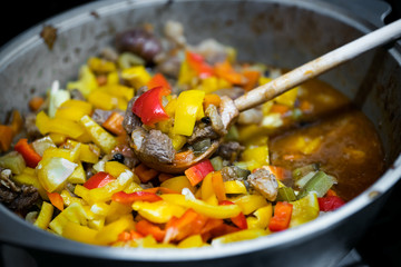 Meat stew with vegetables in a metal dishes. View from above