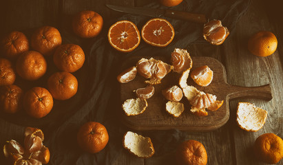 ripe round tangerines and cut in half on an old vintage cutting board