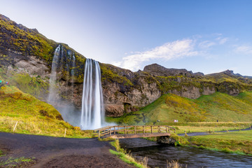 Seljalandfoss waterfall seen from afar with unrecognisable visitors, Iceland