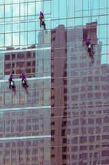 window washers on a highrise office building, sweet tone filter effect