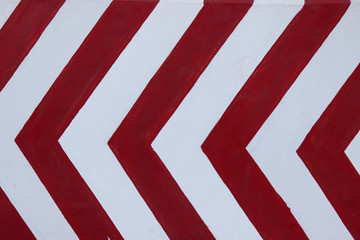 Red and white road marking symbol. Warning road sign. Stripped pattern background.