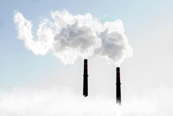 Smokestack sending out plumes of white smoke
