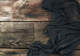 black kitchen textile towel folded on a gray wooden table from old boards