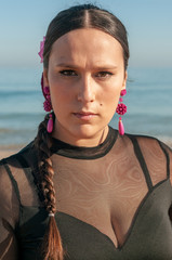 Young Spanish woman dancing flamenco on the beach