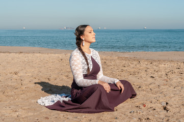 Fototapeta na wymiar Young Spanish woman dancing flamenco on the beach