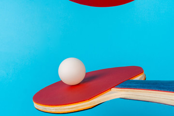 Red ping pong racket on a blue background