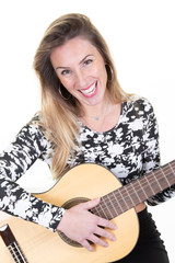 Young woman blonde smiling with a guitar on white background