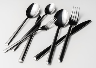 Spoon, fork and knife on a white background