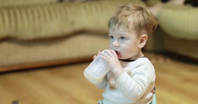 Boy watches TV and eats milk