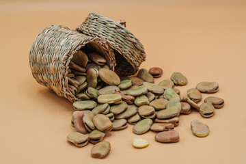 Healthy organic dried broad beans in a straw basket