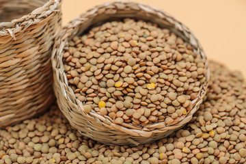 Healthy organic dried lentils in a straw basket