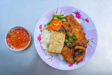 Plate of tasty Vietnamese pork chop rice on table