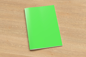 Green brochure or booklet cover mock up on wooden background. Isolated with clipping path around brochure. Side view. 3d illustratuion