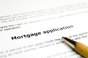 Mortgage application with wooden pen