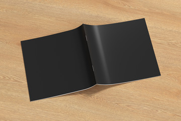 Black square brochure or booklet cover mock up on wooden background. Brochure is open and upside down. Isolated with clipping path around brochure. Side view. 3d illustratuion