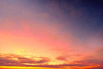 Orange sky at sunset and red clouds landscape against bright star on black universe background....